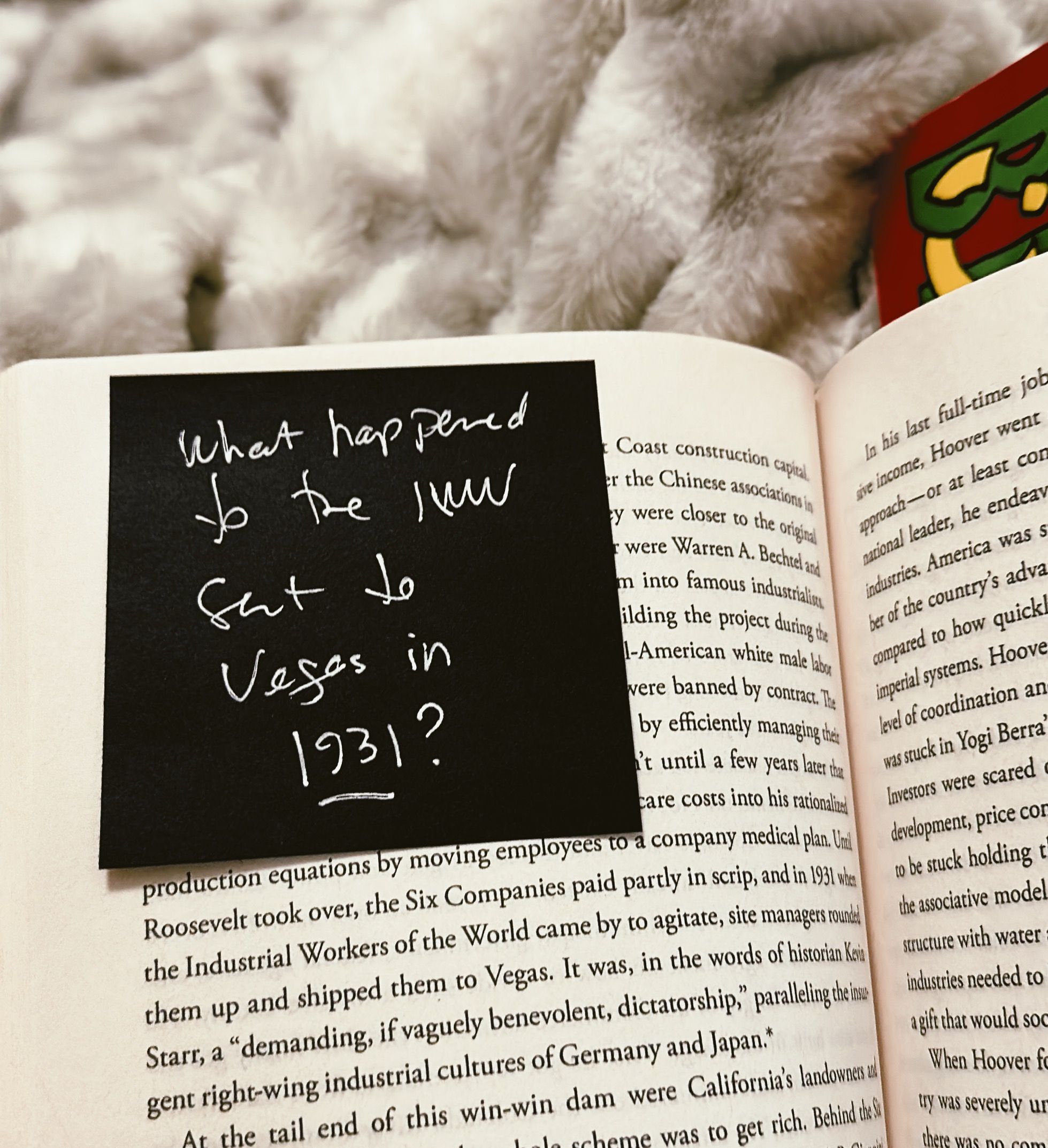 image of the book PALO ALTO on a fluffy white faux fur blanket, with a black post-it note on the page reading, "What happened to the IWW sent to Vegas in 1931?"